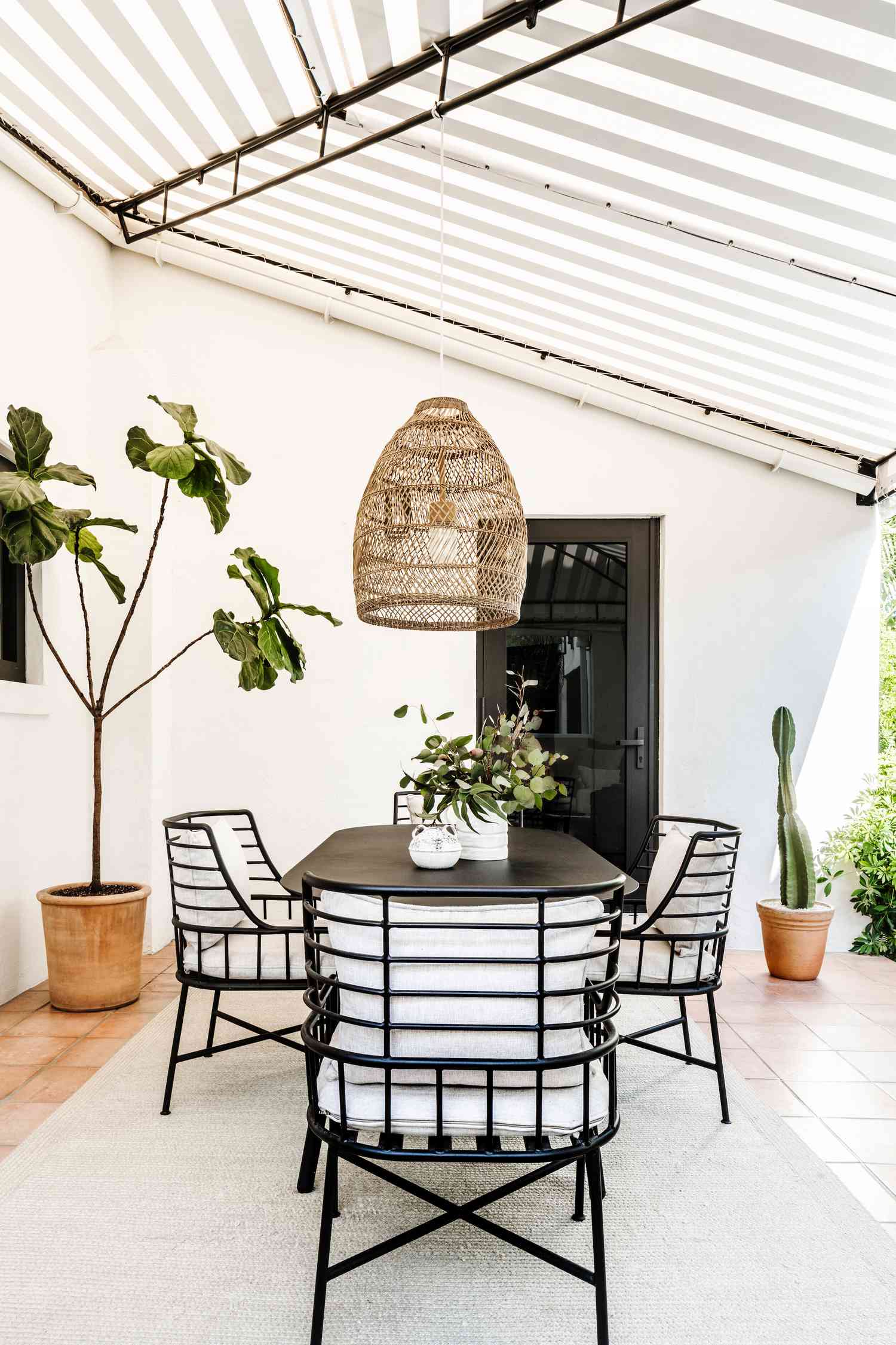 Patio with black and white furniture and a black and white house exterior