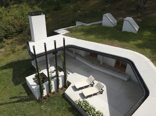 Aerial view of modern house with shaded terrace, UK home