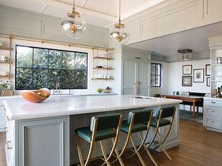 A modern kitchen design with wainscoting and wall paneling.