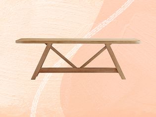 Crate & Barrel Aya Natural Wood Dining Table by Leanne Ford on a peach background