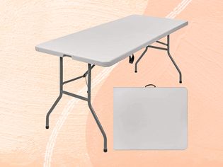 A folding table on a light orange background