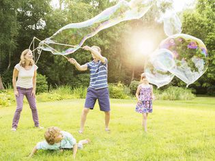 A picture of a family playing with bubbles