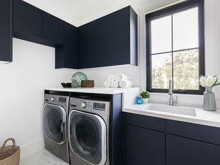 Laundry room with black cabinets built to specifications