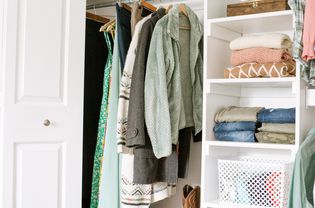 Crammed closet with saved clothing cluttering small closet