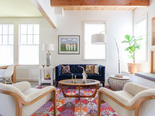 colorful home with patterned rug and arc lighting