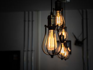 Illuminated pendant lights with incandescent amber bulbs hanging at home
