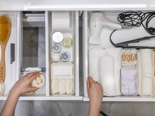 An overhead shot of organized bathroom drawers with dividers