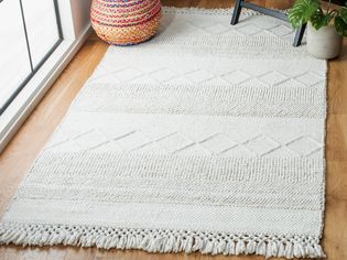 White woven rug on a hardwood floor