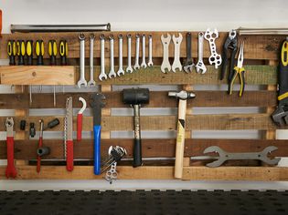 wooden french cleat wall used as tool storage 