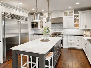 White and gray kitchen with laminate wood flooring