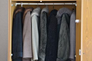 Coat closet with women's coats hanging