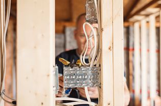 Electrician installing electricity, generating power in a home remodel