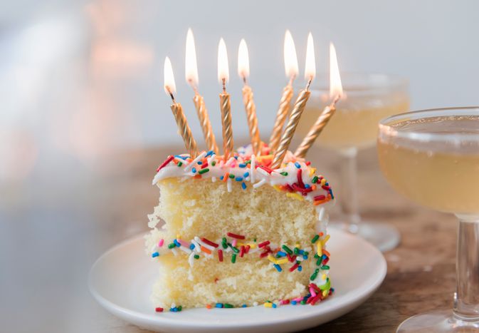 A piece of cake with lit candles