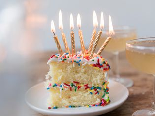 A piece of cake with lit candles