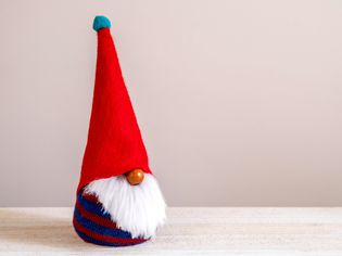 DIY garden gnome with pointy red hat & white faux fur beard