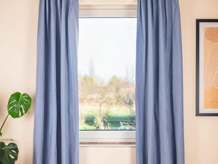 Front view of simple lined curtains hanging from a curtain rod