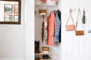 Coat closet organized with bag hooks, wire shelves and shoe bench