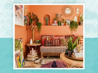 Justina Blakeney living room warm terra cotta walls, plants, and colorful rug, pillows, and wall art for Jungalow