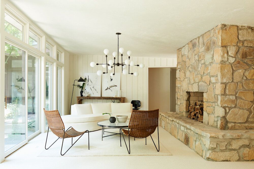 modern living room with large stone fireplace 