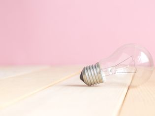 Light bulb lying on a wood surface