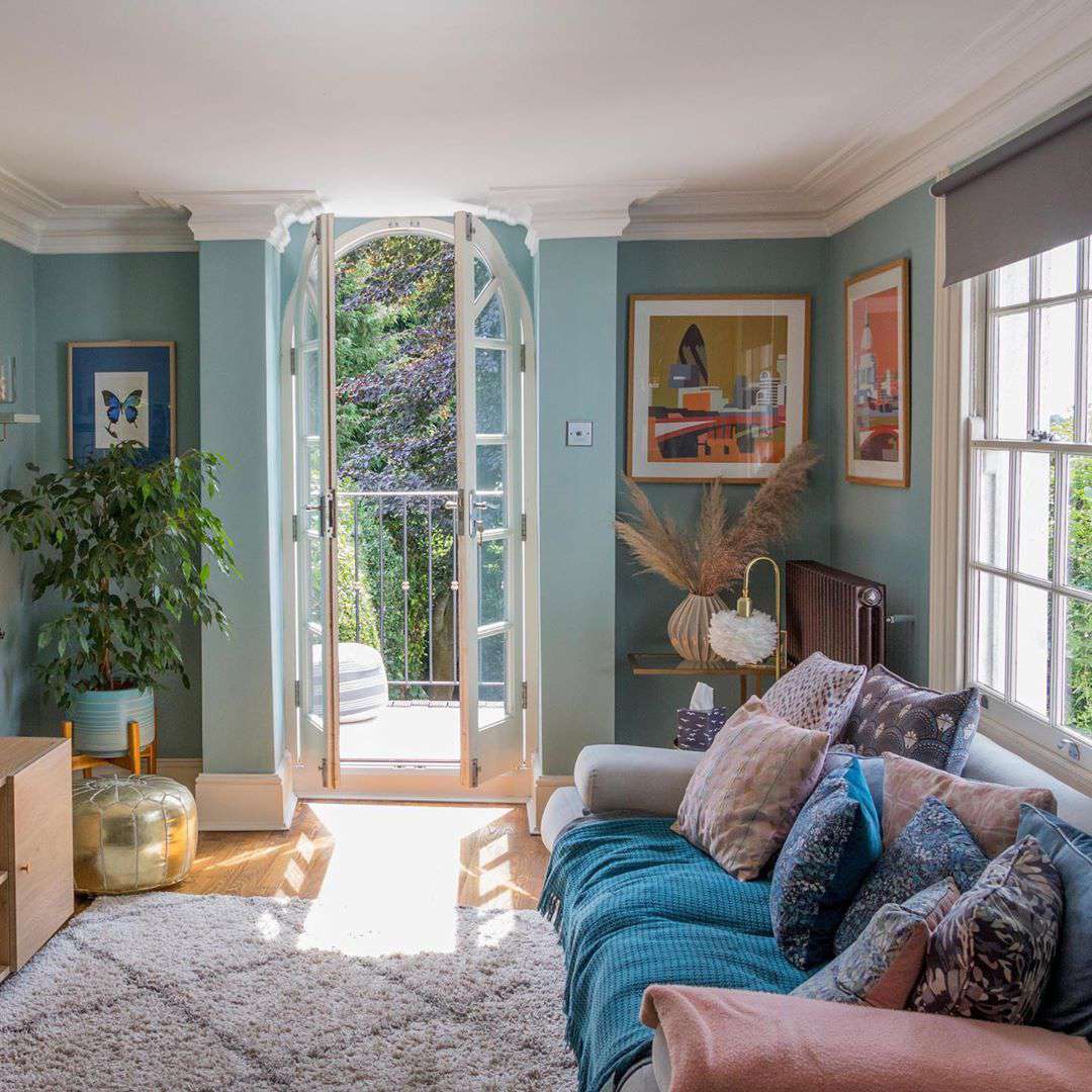 Family room with blue walls and light colors