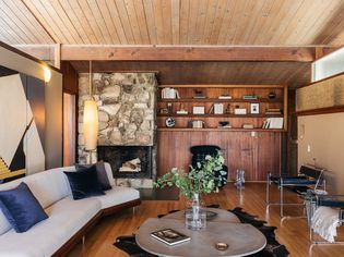 Mid-century modern living room with wooden shelving and modern seating