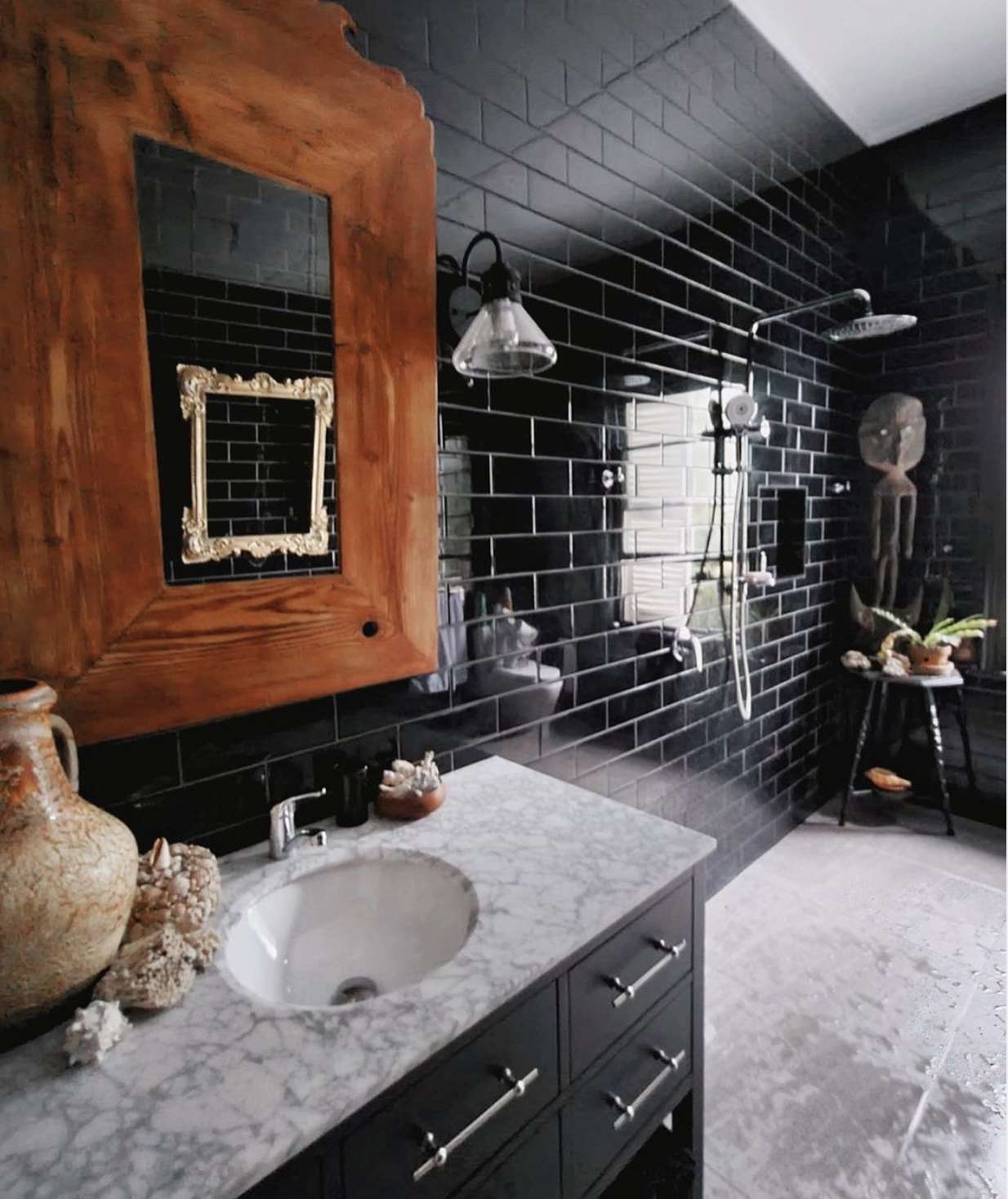 modern black bathroom with rustic mirror