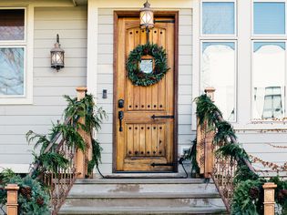 Front door entrance covered with natural Christmas decorations