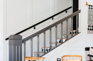 Painted staircase with gray railing and black and white patterned steps