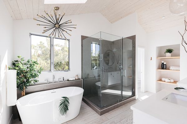 Spa-like bathroom with white garden tub and glass enclosed shower