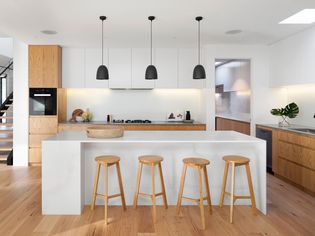 modern wood and white kitchen with a large island
