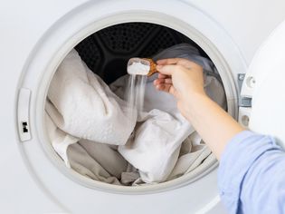 Placing baking soda in the washer to neutralize odors and prevent mold and mildew