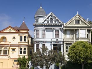 with gables and turrets, three brightly painted Victorian homes line the streets in San Francisco
