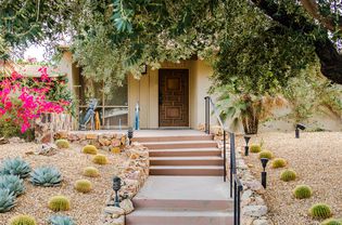 Mid-century modern front entrance with wooden geometric door