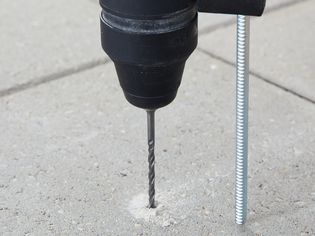 Closeup of how to drill into concrete