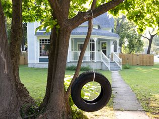 DIY tire swing hanging from a tree branch