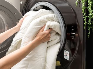 Side angle view of person washing a comforter 