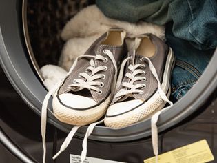 Front view of sneakers in an open washing machine