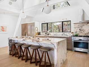 Fresh modern kitchen with granite accents and vaulted ceiling