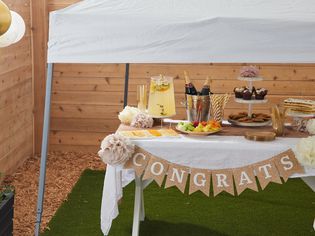 Party table underneath a white canopy covering