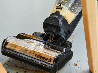 The Bissell Crosswave Hydrosteam vacuum mop being used to mop up coffee and orange juice.