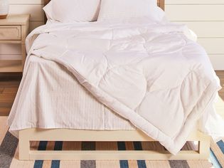 White wooden bed adorned with a Buffy Cloud Comforter 