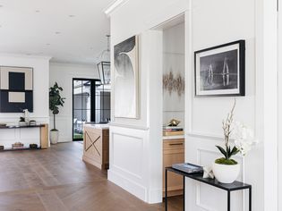 Open entryway with white-painted wainscoting panels