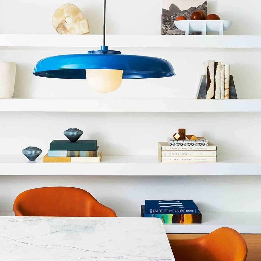 Table with a bold blue pendant lamp