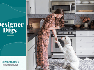 Designer Elizabeth Rees in her kitchen with her white dog.