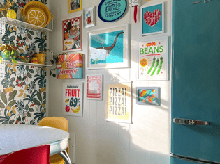 A retro kitchen with a gallery wall