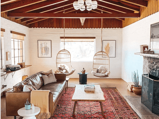 A Southwestern-style living room with wooden ceiling beams.